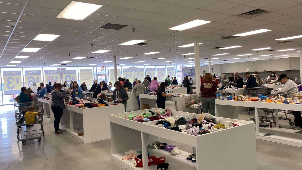 Shoppers browsing through various bins filled with discounted products inside a busy bin store, illustrating strategies to find the best deals.